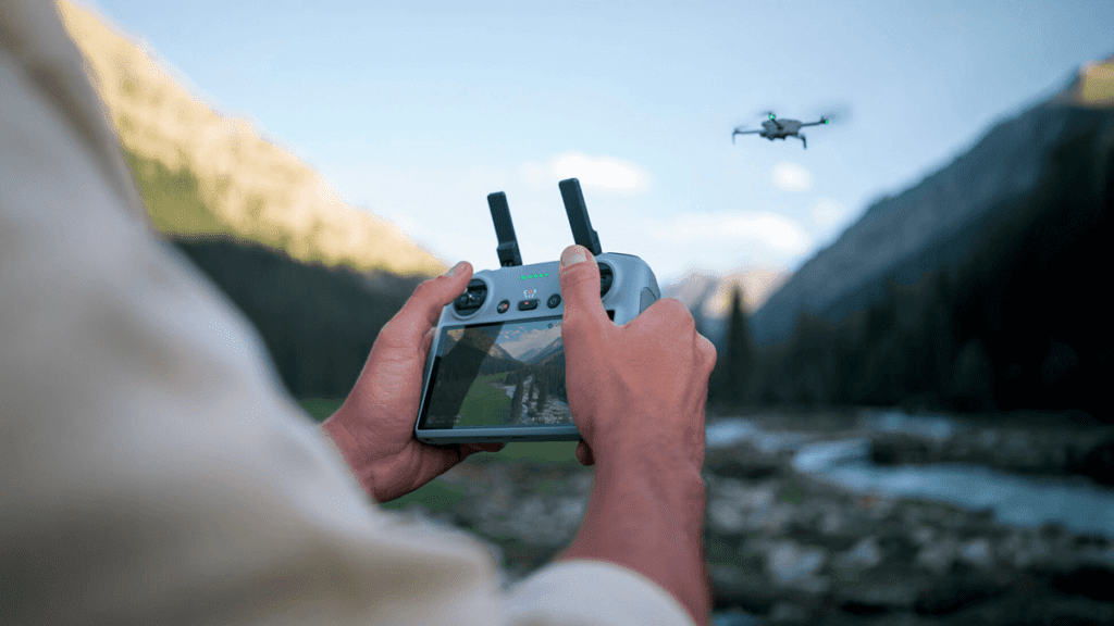 Uma pessoa pilotando o drone dji mini 4 pro usando seu modo de voo inteligente.